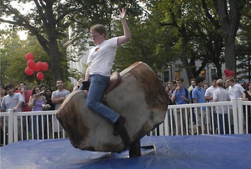 Students vied to ride the mechanical bull, the same one featured in the movie “Charlie’s Angels,” at the Harvard State Fair on Friday in Tercentenary Theatre. Over 5,500 students, faculty, and staff enjoyed the first-ever festivities, which included 