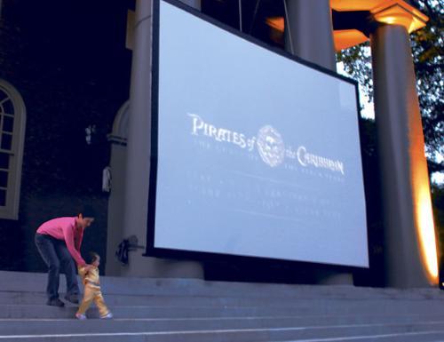 Carey Allen and her daughter Emma head for their seats before last night’s outdoor screenings of “Pirates of the Caribbean” and “Batman Begins” in Tercentenary Theatre. It was the fourth annual “It’s Movie Time at Harvard” event.