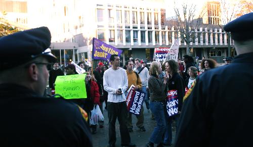 Police look on as students gather in support of the Justice for Janitors march yesterday afternoon in front of the Science Center. The march was held in support of living wages for Harvard janitors.