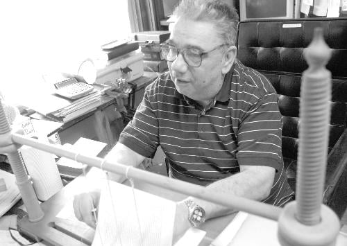 Robert Marshall, a bookbinder, works at the Harvard Book and Binding Service on the third floor of the building at the corner of JFK and Brattle Streets. Marshall has worked in the Square for the last 36 years.