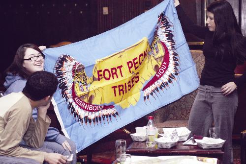 April D. Youpee-Roll ’08 and Elijah M. Hutchinson ’06 display traditional tribal items at “Represent Your Tribe” night yesterday.