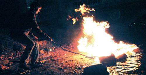 Freshmen releasing their burning sacrifices into the Charles for River Run in 2006.
