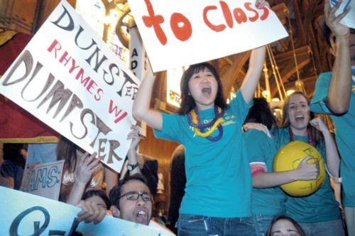 Quincy House upperclassmen scream in greeting incoming freshmen at Annenberg yesterday. A welcoming crowd also gathered outside, including House mascots and HoCo members. Freshmen received their respective housing assignments early yesterday morning.