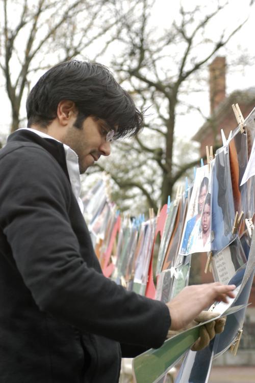 <i><font size=2>
<p align=left>Outside the Science Center, Ravi K. Manglani ’08 peruses a presentation on AIDS in South Asia at the kickoff event in a week designed to raise awareness.</p></i></font>