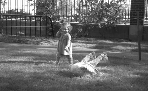 Eleanor (left), 1, and Elizabeth, 3, von der Heydt, children of Winthrop House Resident Dean James E. von der Heydt, frolic and tumble alongside students in the afternoon sunlight in the Gore Courtyard of Winthrop House yesterday. 