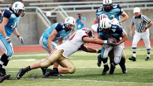 Matt Thomas ’06-’07, the captain of the Harvard football team (pictured here in white), was arrested on June 5 and charged with assault and battery.