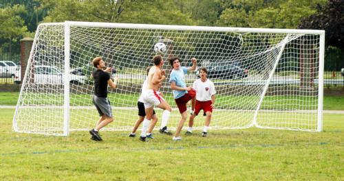 Students and proctors vie for the ball during an intramural soccer game on Friday, July 28.