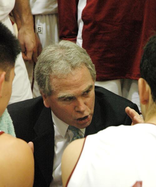 Frank Sullivan, the current Harvard men’s basketball coach, speaks with members of his team. He will not return next year. 