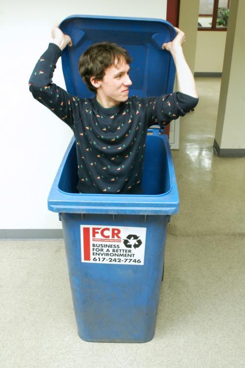 Cowles maintains his smile, even after being shoved in a recycle bin.