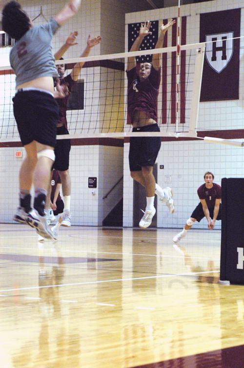 Vassar's Phil Tully, left, tries to slam one past Favrot and senior Andy Nelson (8 blocks). The Crimson defense held Vassar to .176 hitting in the decisive fifth game.