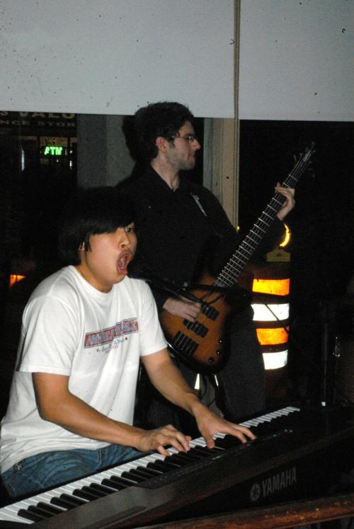 Steve Lin '08 (left) and Burak Tekin '08 (right) of the band Dharma Seals play at the Battle of the Bands in Quincy House JCR Saturday evening.