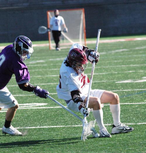 Who moved the chair? Sophomore midfielder Kirk Bansak leans back trying to recover a loose ball during Harvard’s 12-9 Stadium win over Holy Cross.