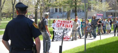 SLAM protesters march through the Yard on Monday in opposition to what they are calling unjustly low wages paid to the AlliedBarton security workers. Those participating in a hunger strike fasted for the sixth consecutive day Tuesday, as one striker was h