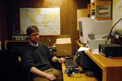 Clayton M. Nall, a doctoral student at the Graduate School of Arts and Sciences and station manager for the Harvard Wireless Club, sits in front of a ham radio in the clubhouse of W1AF. 