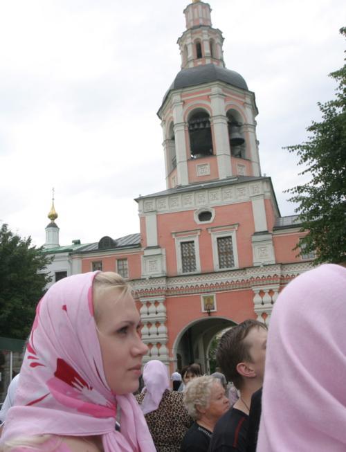 Crowds of worshippers watch the consecration of Lowell House's new bells in Moscow on Tuesday. The Danilov Monastery's belltower, the past and future home of the 17 bells that have hung in Lowell since 1930, is in the background.