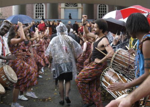 The Harvard College Pan-African Dance and Music Ensemble led the academic procession to the stage on the steps of Memorial Church. The troupe lined the central aisle between thousands of folding chairs as Faust and select well-wishers filed onto the stage