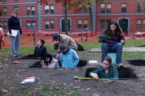 Students in Anthropology 1130, “The Archaeology of Harvard Yard,” dig for 17th-century artifacts in front of Matthews Hall yesterday afternoon. The location was the site of the Harvard Indian College from 1655-1698.