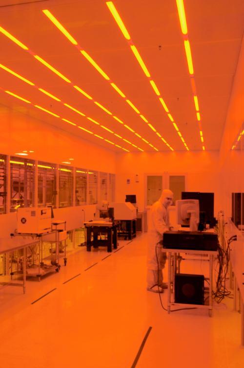 Mac Hathaway, staff engineer, works in the “cleanroom” of the LISE building. Orange light is less harmful to the industrial material photoresist.