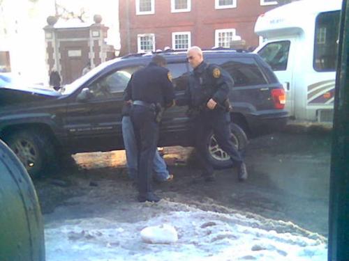 Police arrest a man at the site of the Dec. 18 accident.