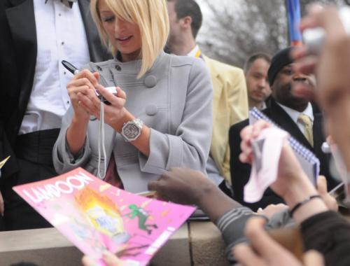 Paris Hilton signs a digital camera in front of the Lampoon yesterday shortly after accepting the magazine’s “Woman of the Year” award.