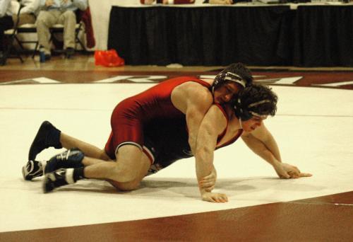 Despite stretching his personal win steak to six, senior Matt Button, shown here in earlier action, couldn’t help his squad eke out its third victory of the season. The team, already plagued by injuries, saw yet another wrestler fall early on, setting the