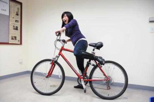 A completely unbitter Jun Li now cruises on a two-wheeler with style.  Kind of.
