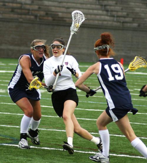 Despite a three assist, one goal effort from junior Kaitlin Martin, shown here in earlier action, the Harvard women’s lacrosse team suffered its first loss of the season at the hands of UNH. Martin had a hand in four of the Crimson’s five goals in a blowo