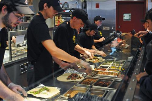 Chipotle staff, shown here during yesterday’s “free burrito” promotion, served about 3,000 hungry patrons during the course of the rainy day. 