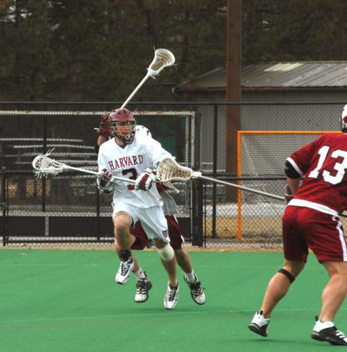 Senior midfielder Zach Widbin, shown here in earlier action, ran the offensive attack for the Crimson against Denver, scoring a career-high four goals in the losing effort. Two of his goals gave Harvard a 6-3 edge at halftime, while his other two gave his