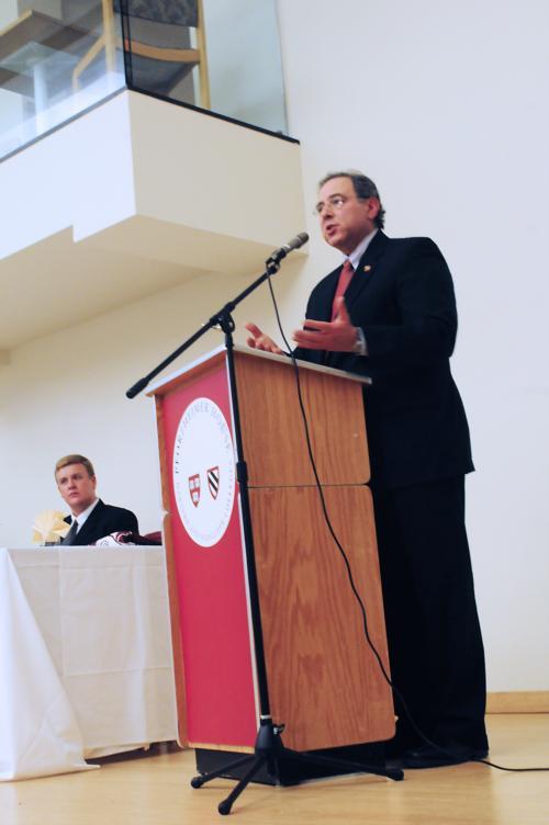 Jonathan Hawley ’10, vice president of the Harvard Dems, looks on as Congressman Paul Hodes addresses the audience at the fourth annual Harvard Dems Award Gala on Saturday night in Pforzheimer. 