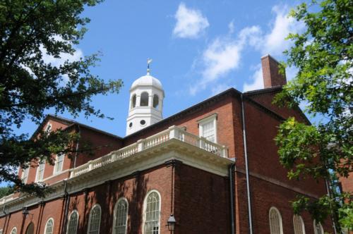 Harvard Hall, one of the University's oldest buildings, sits against a backdrop of rare blue skies.
