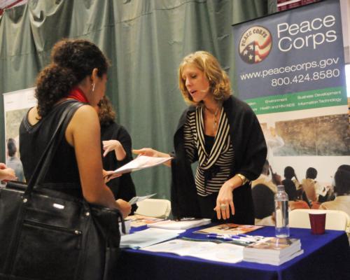 A student speaks to a Peace Corps recruiter at OCS’ 27th annual career fair, which was held amid pouring rain at the Gordon Indoor Track and Tennis Facility. 