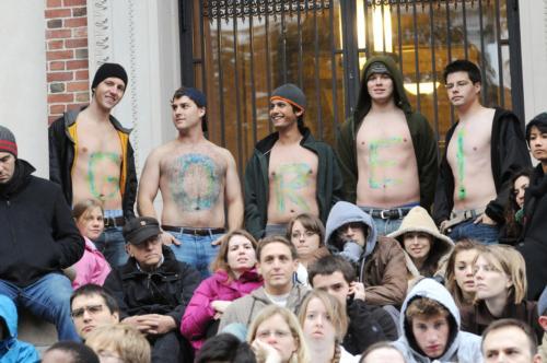 Male undergraduates with chests painted “GORE!” watch Gore's speech.