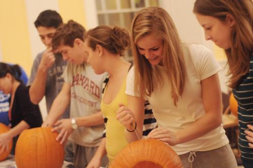 Cassie N. Bowe ’11 and Elizabeth A. Joyce ’11 celebrate Halloween with candy and pumpkin carving in Lowell dining hall yesterday.