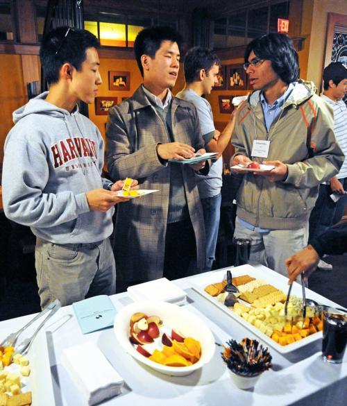 Charles Liu ’11, Jeffrey B. Low ’11, and Krishna M. Prabhu ’11 attend a social mixer for students who have worked on global health and international development projects at the Queen’s Head Pub last night.