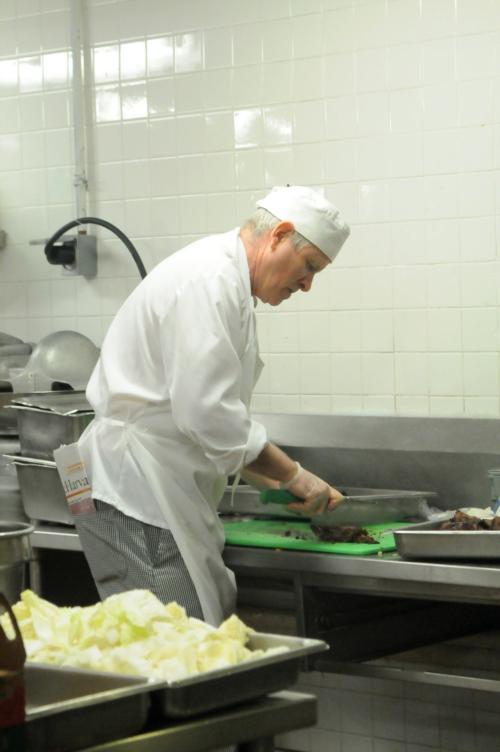 Edward B. Childs cooks in the Adams House kitchen. He is participating in an investigation into alleged anti-gay remarks made by a dining hall manager. 