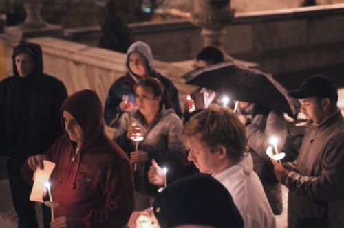 Workers and students of Harvard Medical School brave the rain last night to participate in a candlelight vigil protest against the University's budget cutbacks that have caused worker layoffs.