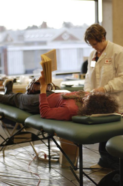 A student reads a book as a nurse prepares her for a blood donation as part of a blood drive in the SOCH yesterday.