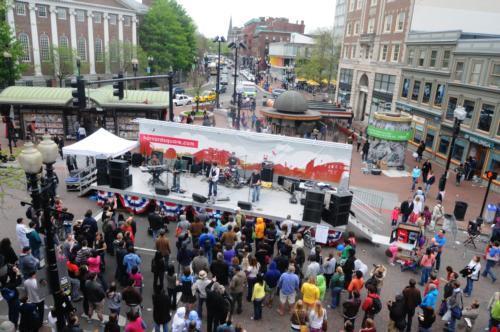 Musical artists perform for the crowds in Harvard Square for Mayfair as vendors and craftsmen line the streets showing their products..