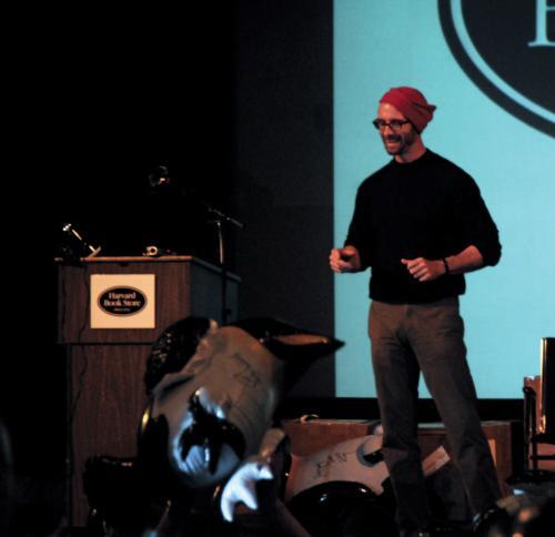 Chuck Palahniuk, author of “Fight Club” and his newest book, “Pygmy,” laughs as the audience competes to blow up signed inflatable penguins yesterday at the Harvard Book Store.