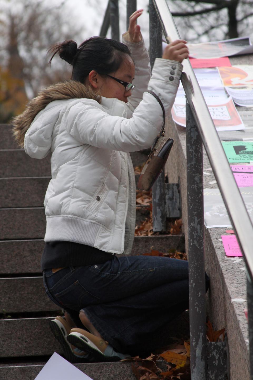 In order to get the best spot for her group’s flyer, Esther Hsiang ‘12 wakes up early to poster on the stairs that lead to Lamont Library.