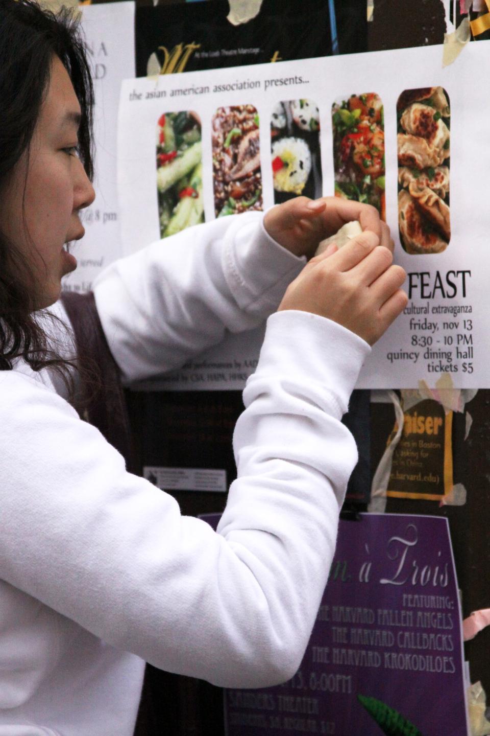 Serena Zhang ‘13 gets up early last Thursday to poster for an event hosted by the Asian American Association.