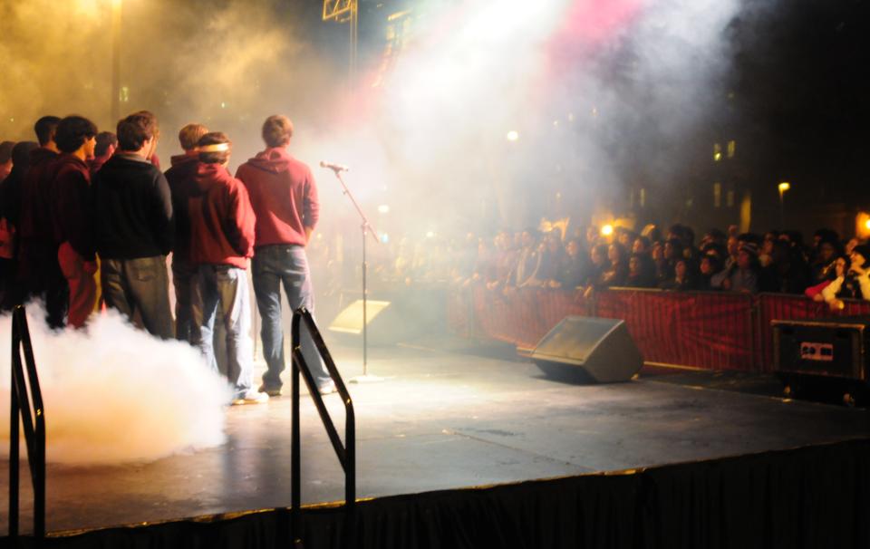 Members of the Harvard Glee Club perform at the Harvard Yale pep rally.