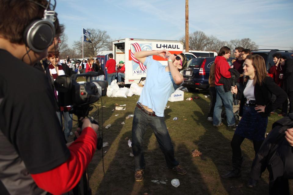 Students at the game showcase their drinking prowess  while tailgating before the beginning of the game. 