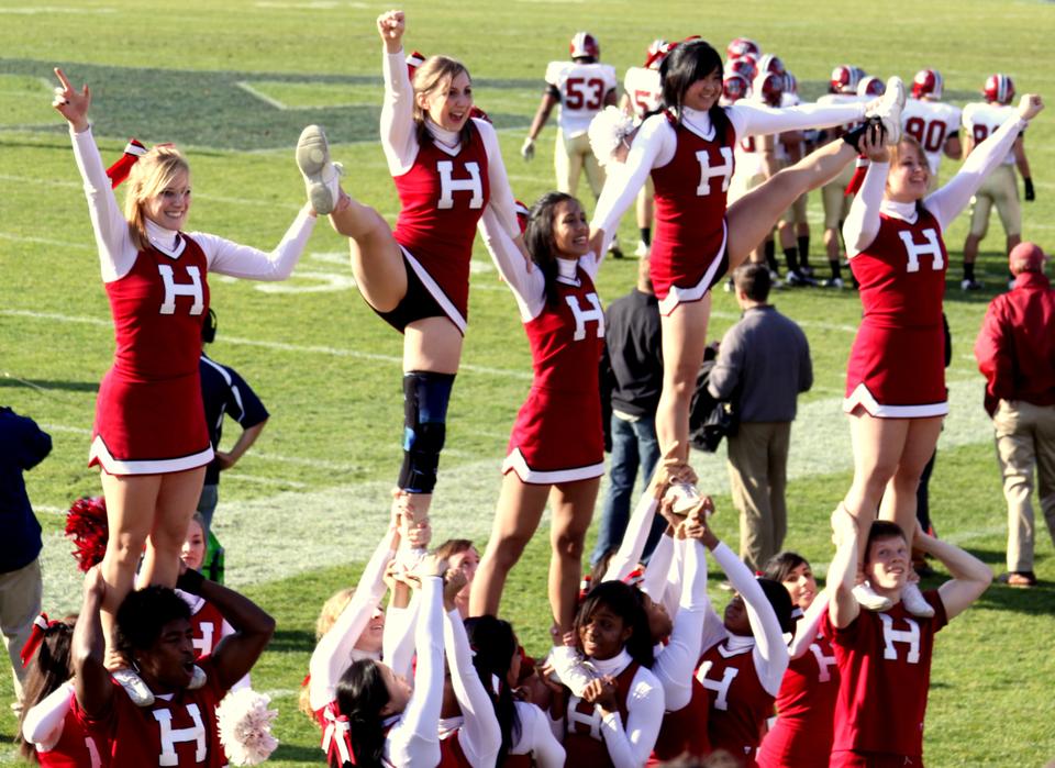 The Harvard Cheerleading Squad energizes students in the stadium.
