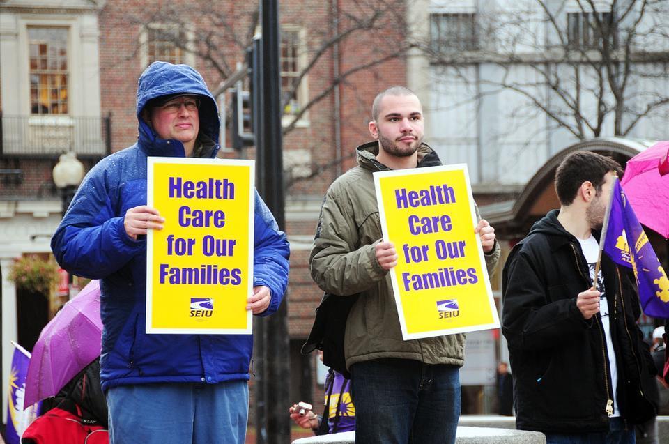 Protesters gather in Harvard Square yesterday to speak out against changes being made to Harvard security officers’ health care plans. Some officers took turns telling their stories. A few students were also present.
