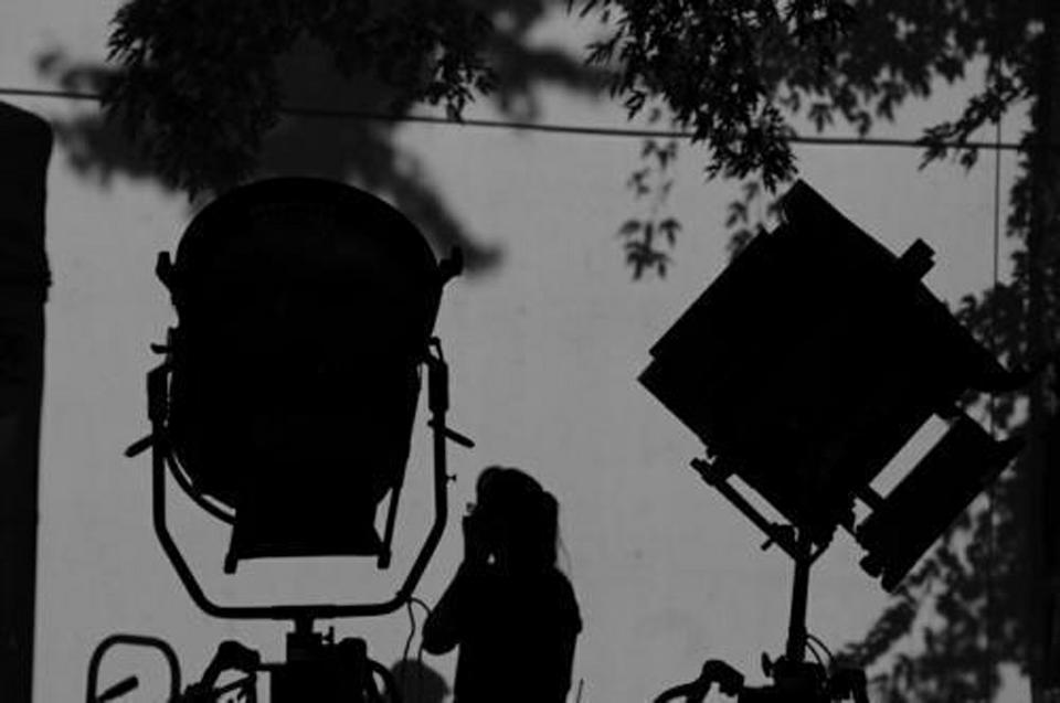 Original Publication Date: September 16, 2009

A filming crew member adjusts various pieces of lighting equipment during the shoot for Ben Affleck's new movie, The Town. The tarps serve to separate the cast from the prying eyes of the public, waiting along JFK Street.