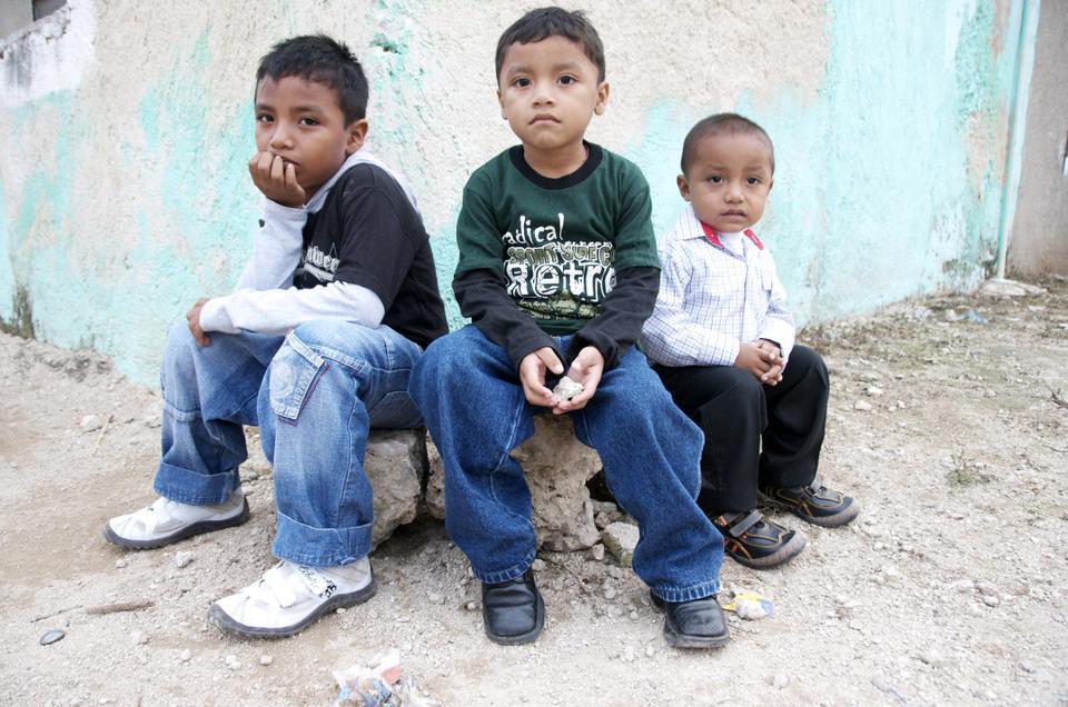 Three boys relax outside their home in the town of Temozon Sur, Yukatan, Mexico on Christmas Day.

