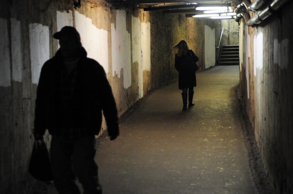 The MBTA has reported a 30% decrease in crime on the T. Two people hurry to catch their respective trains on the State stop on the Blue line. 