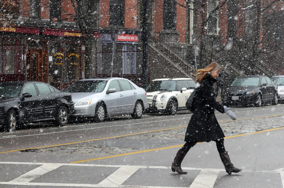 A Boston resident braves the snow yesterday as she walks along Columbus Avenue. 